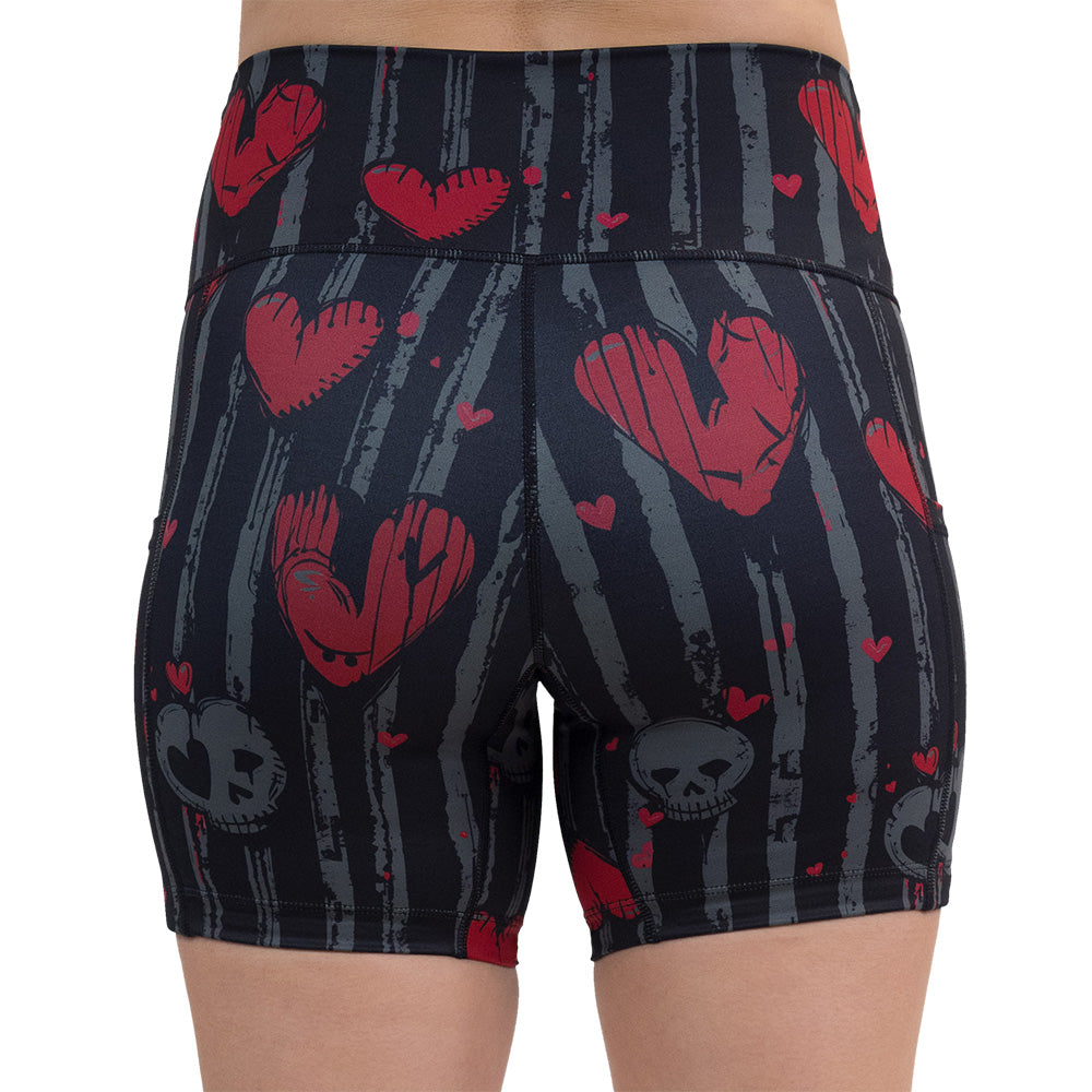 back of the red heart and gray skulls against a black and grey striped background 5 inch shorts against a white background