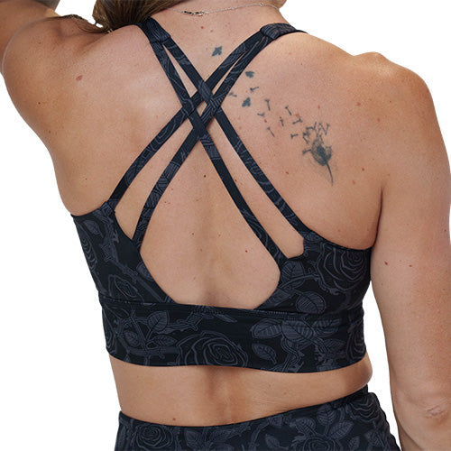 back of the black and grey rose patterned sports bra