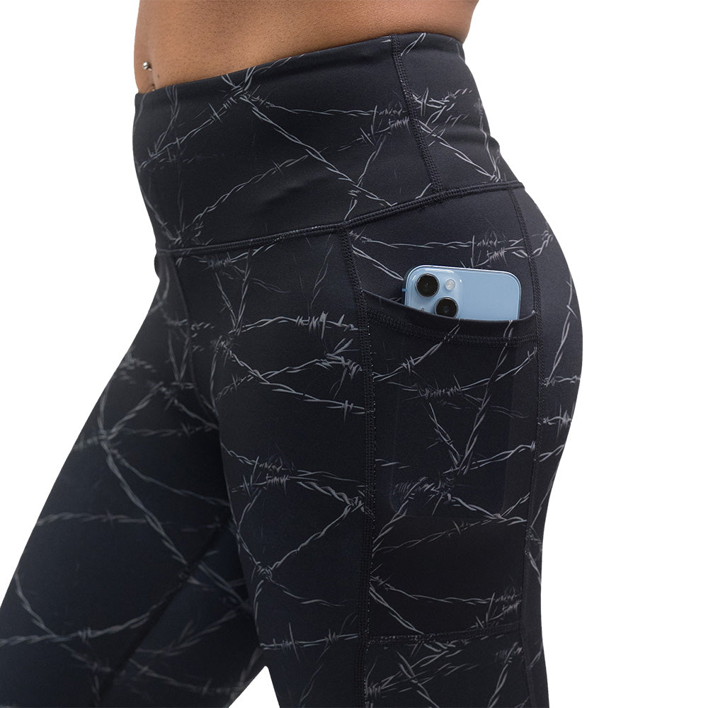 black leggings with a white barbed wire pattern on it