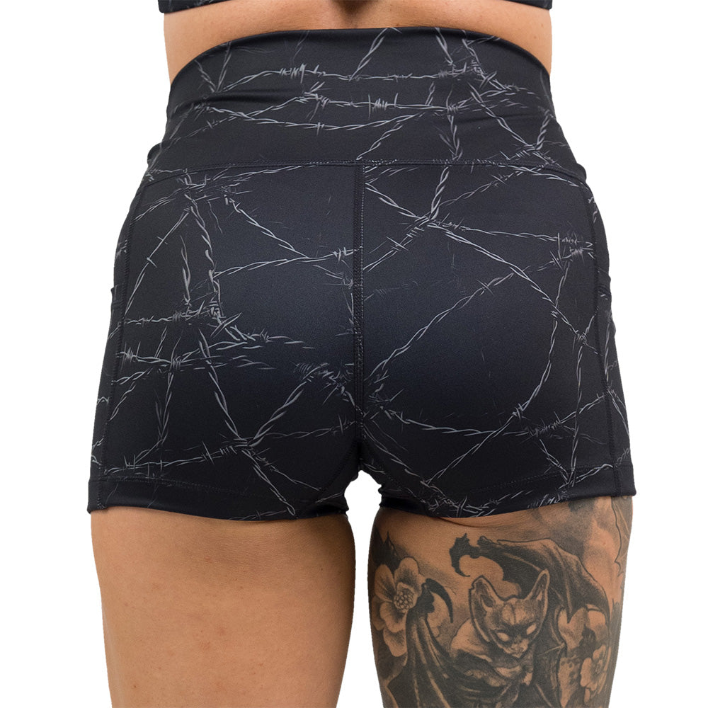back of the black shorts with a white barbed wire pattern on it
