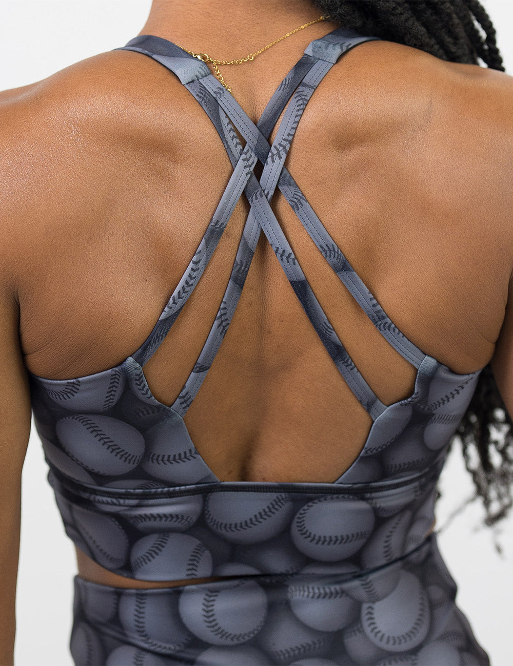back of the dark grey baseball themed longline bra against a white background