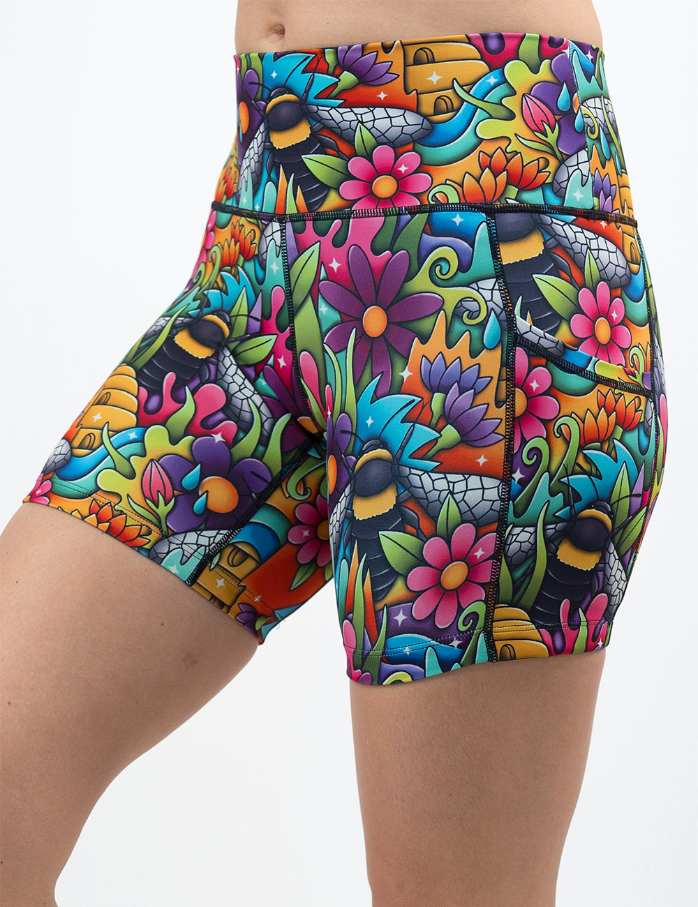 front of the cartoon bees against colorful cartoon flowers 5 inch shorts against a white background