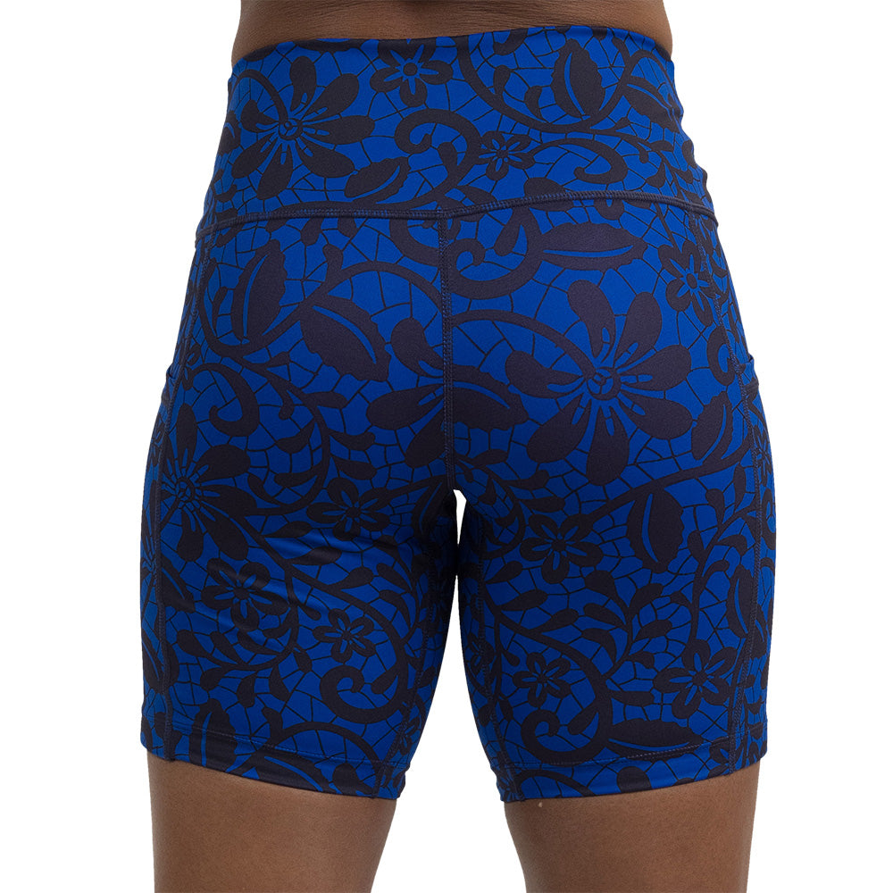 back of the 7 inch black floral against a dark blue background shorts against a white background