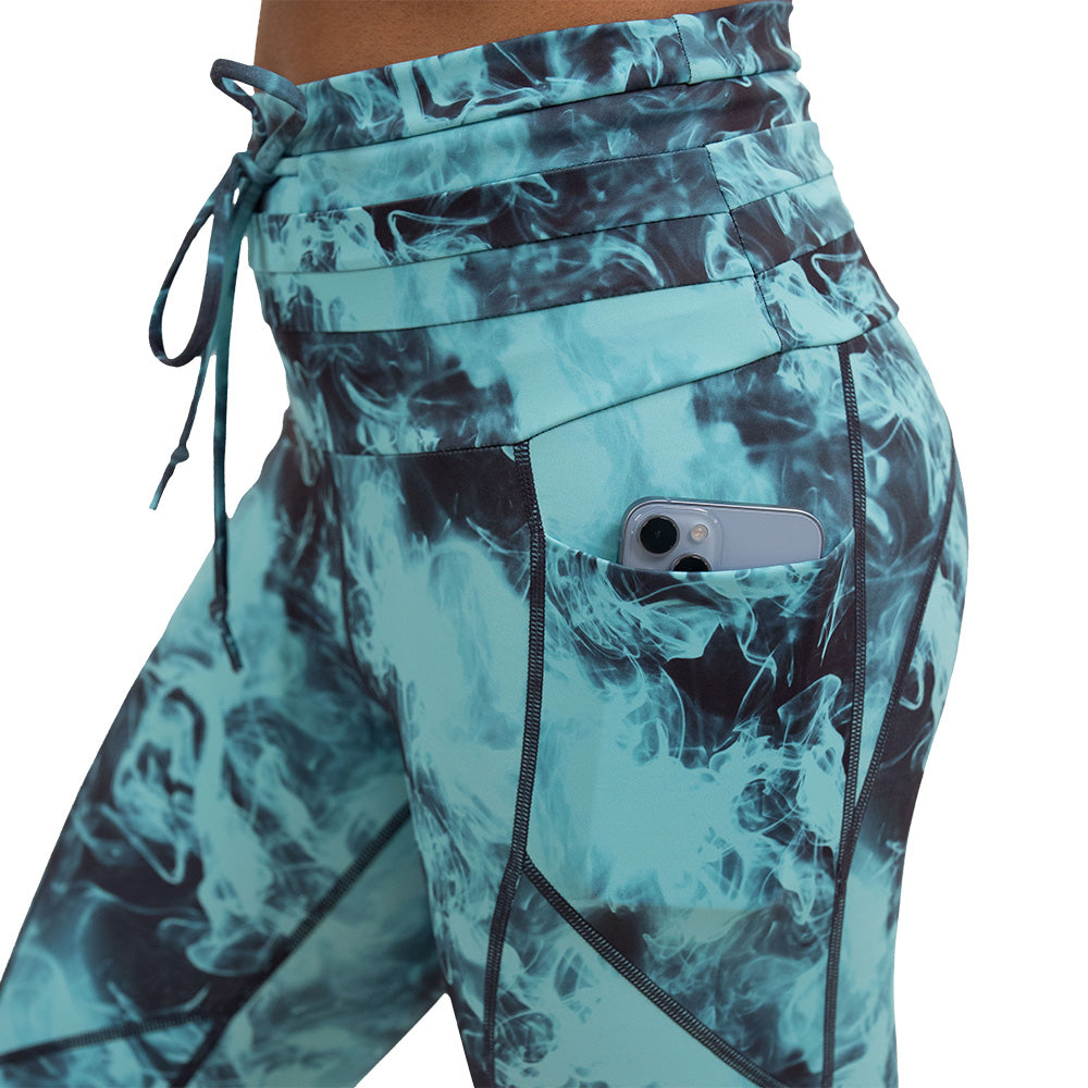 close up of the blue smokey leggings pocket holding a phone against a white background