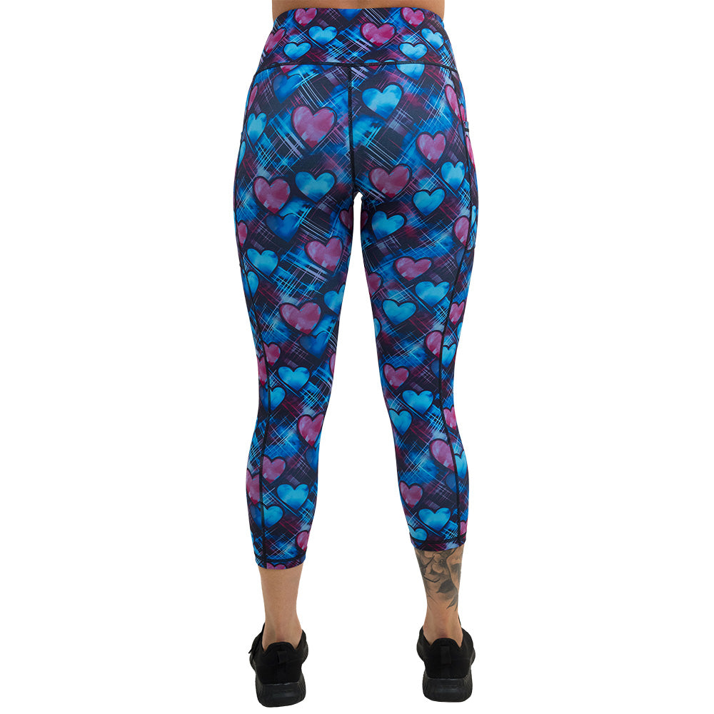 back of the blue and pink hearts pattern against a dark stitched background capri leggings