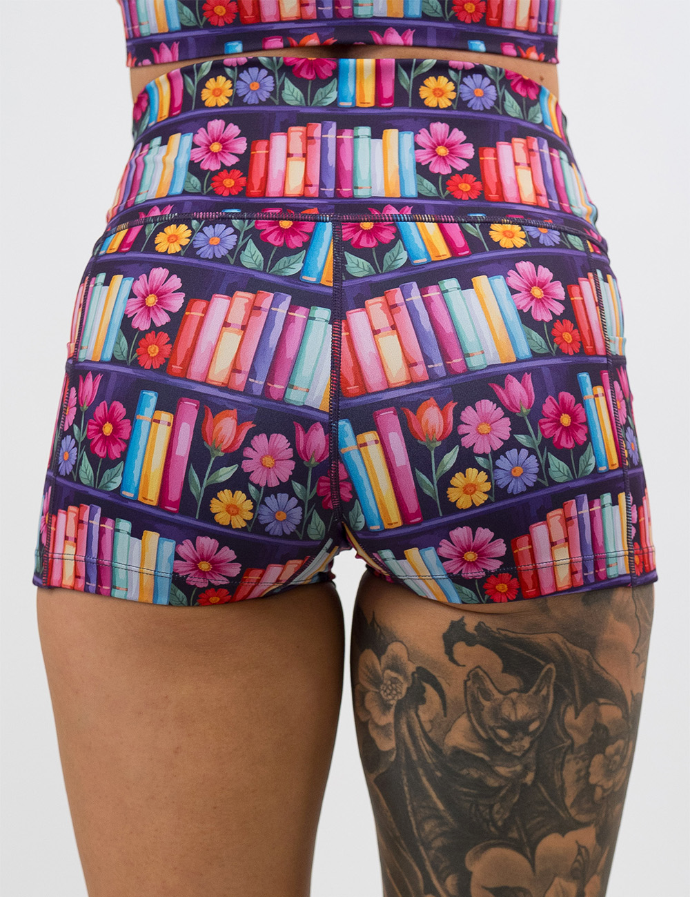 back of the brightly colored books and flowers 2.5 inch shorts against a white background