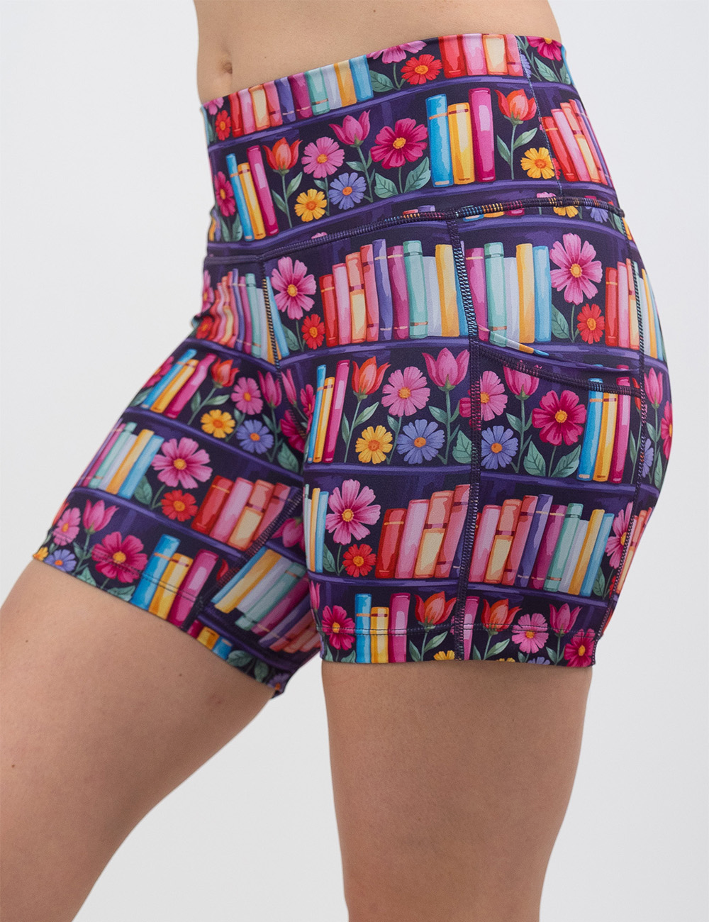 5 inch brightly colored books and flowers print shorts facing the front against a white background
