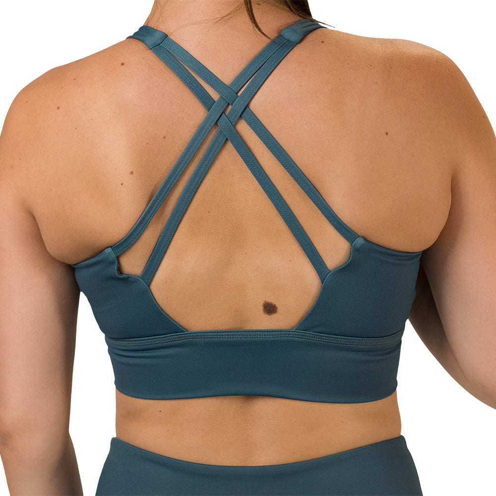 back of the Teal sports bra with black leaf pattern on a white background