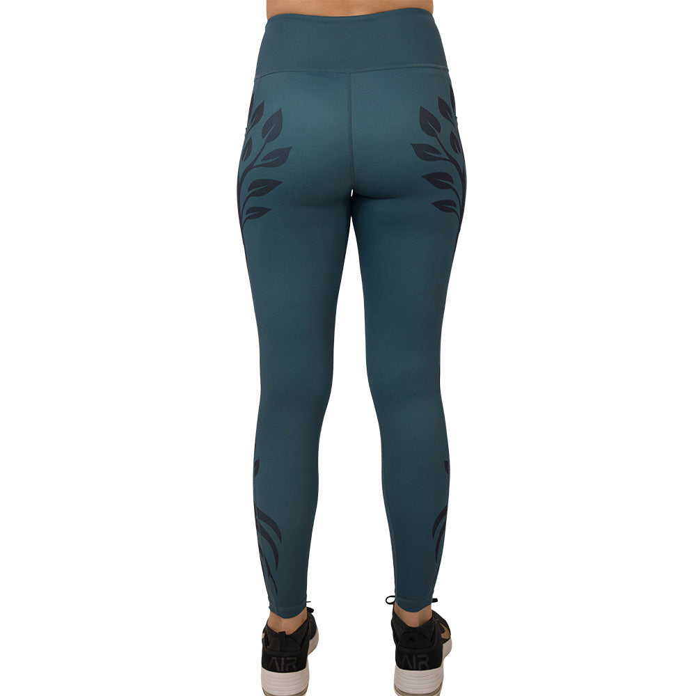 back of the Teal leggings with black leaf pattern on a white background