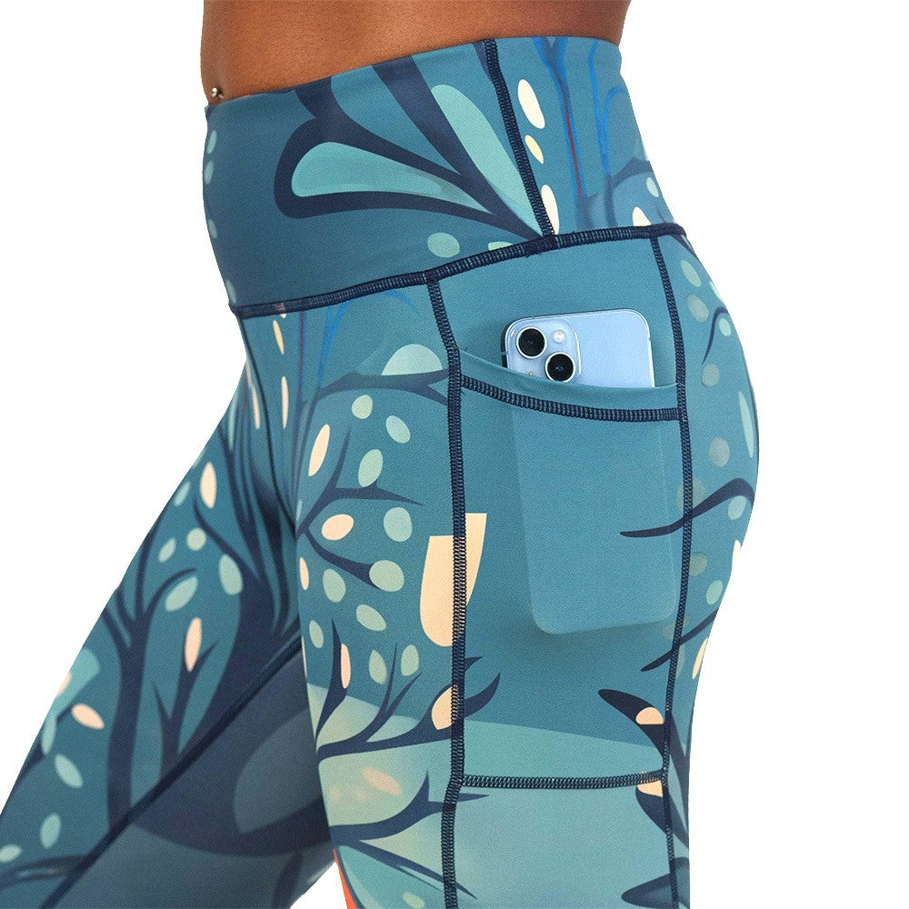 Blue leaf-patterned leggings with a pocket holding a phone on a white background