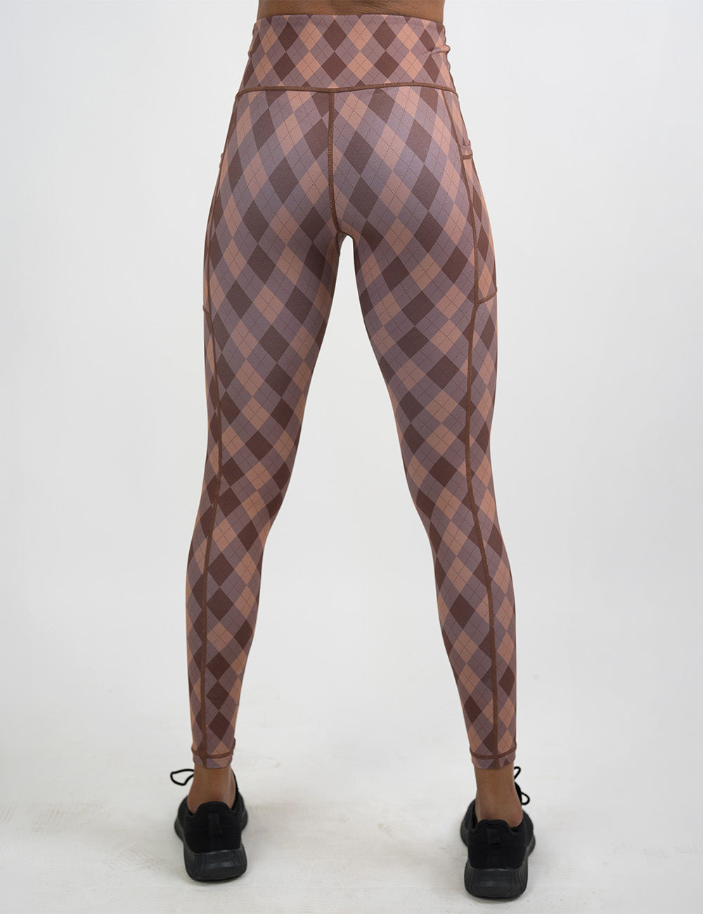 back of the full length grey, beige, and dark red plaid leggings against a white background
