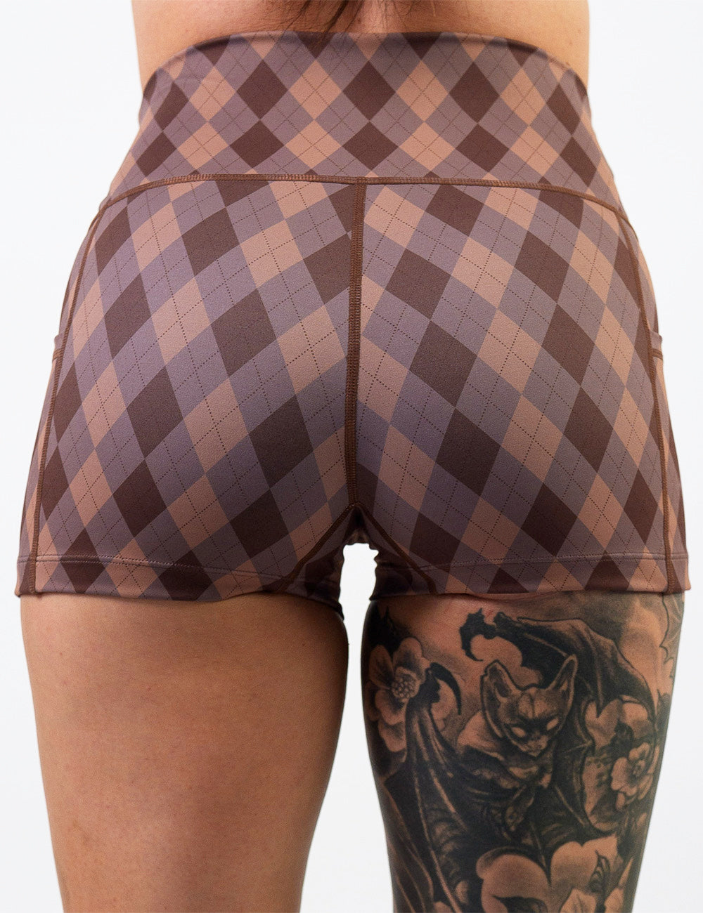 back of the 2.5 inch beige, grey, and brown plaid shorts against a white background