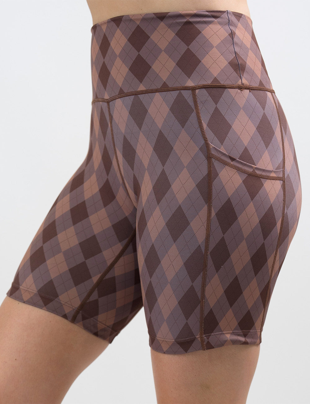 front of the 7 inch beige, grey, and brown plaid shorts against a white background