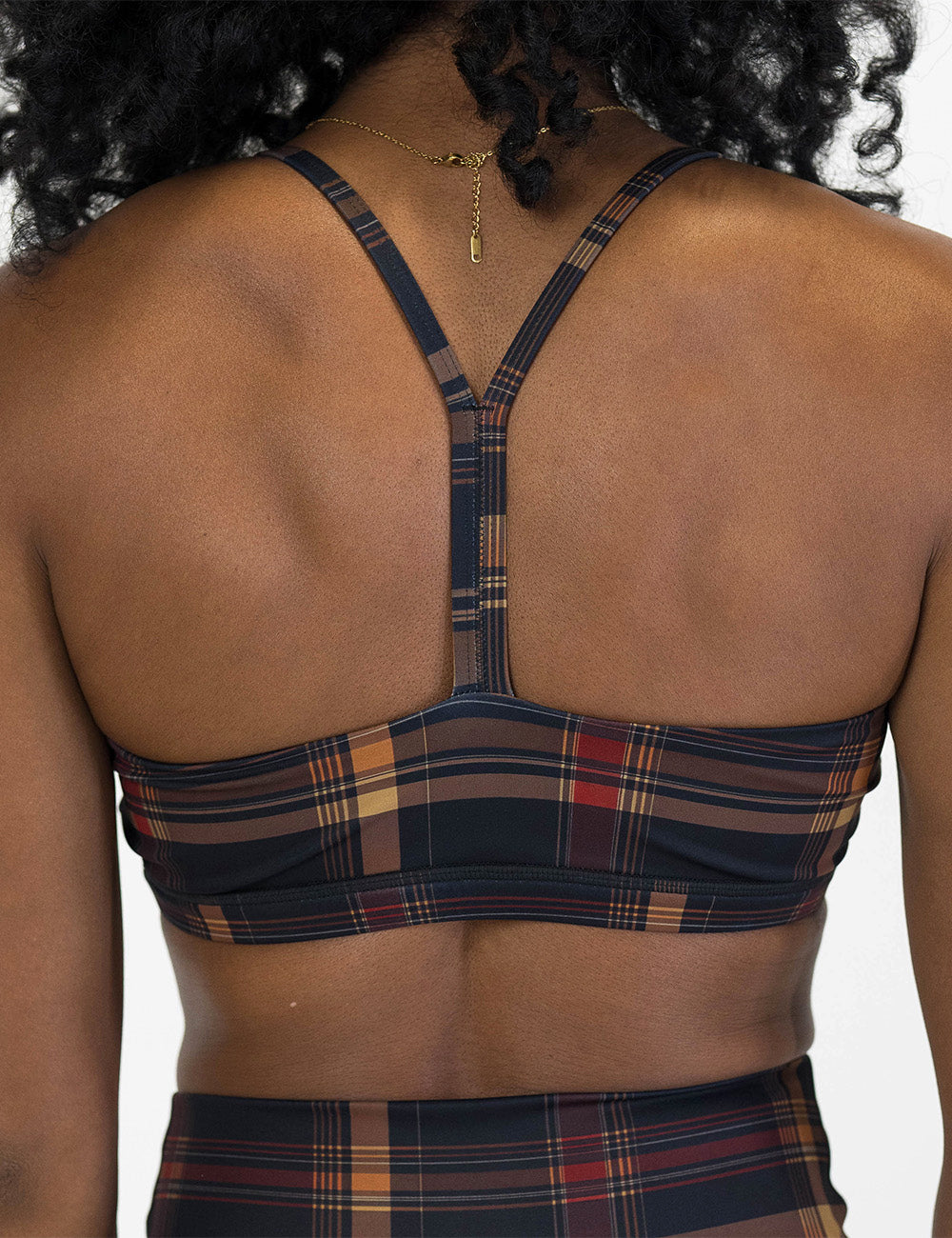 back of the black, red, and yellow plaid bra against a white background