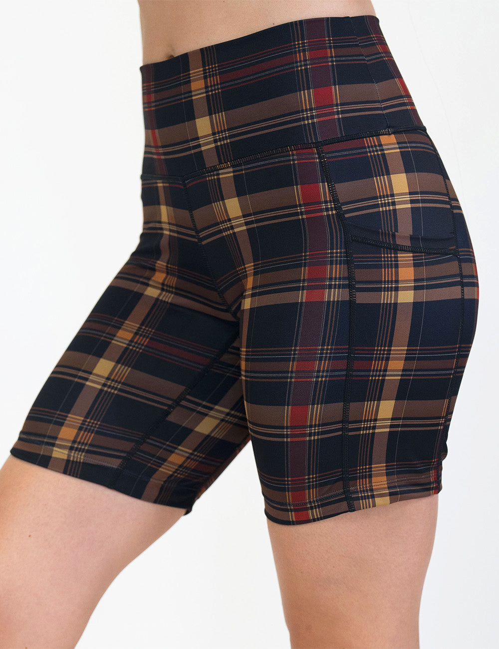 front of the 7 inch black, red, and gold plaid shorts against a white background