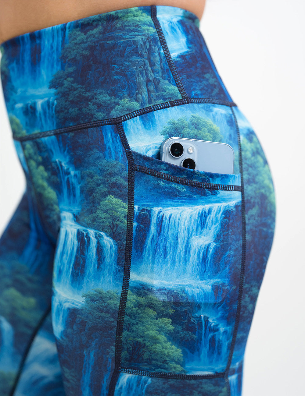 close up of the waterfall leggings with a phone in its pocket against a white background