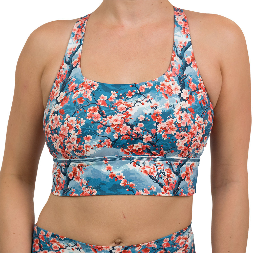 front of blooming cherry tree print longline bra against a white background