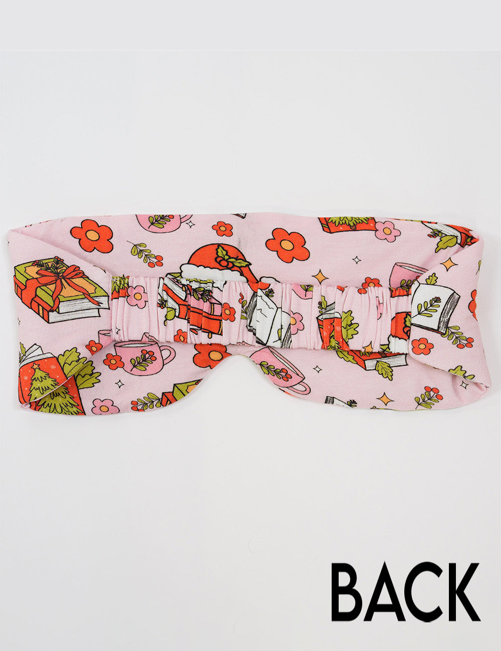 back of the Christmas books and flowers all over pink eye mask