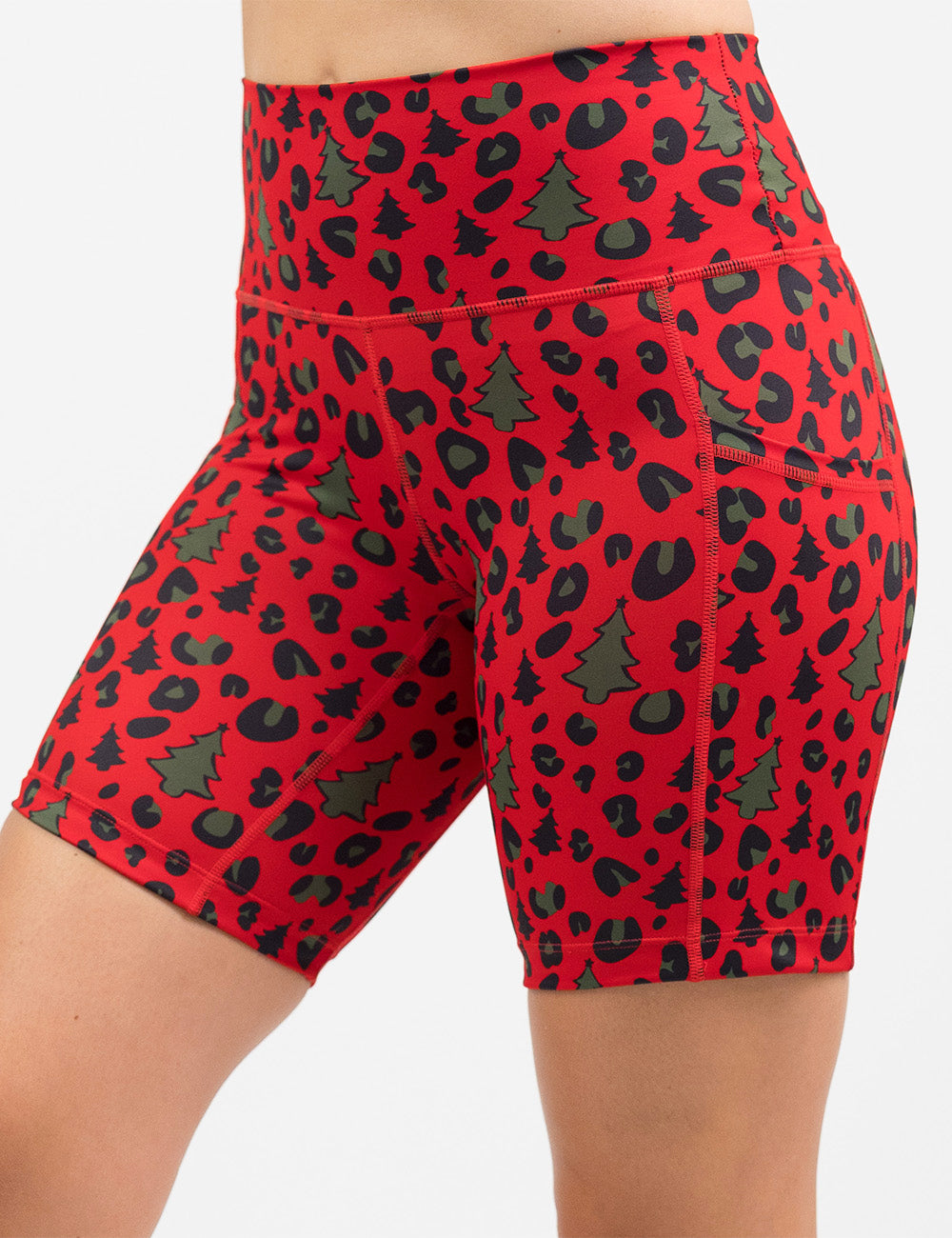 front of the red and brown Christmas trees and leopard print 7 inch shorts against a white background
