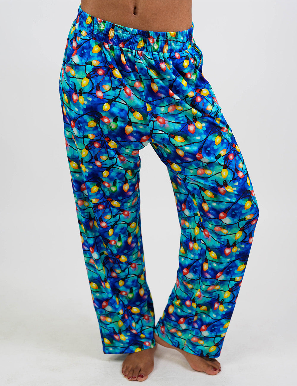 front of the Christmas lights in front of  blue and teal background pajama bottoms against a white background
