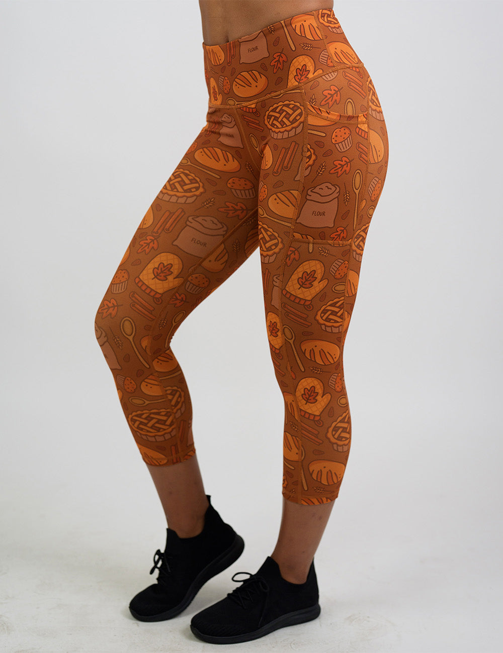 front of the orange baking themed capri leggings against a white background