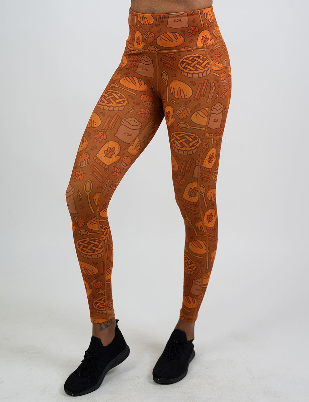 front of the orange baking themed full length leggings against a white background