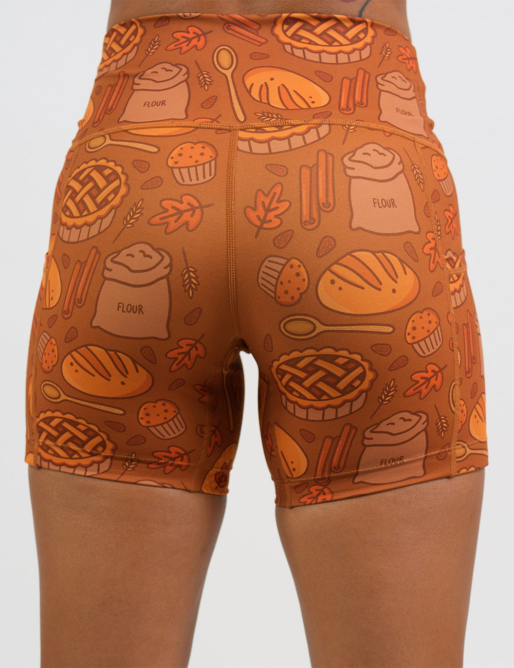 back of the 5 inch orange baking themed shorts against a white background