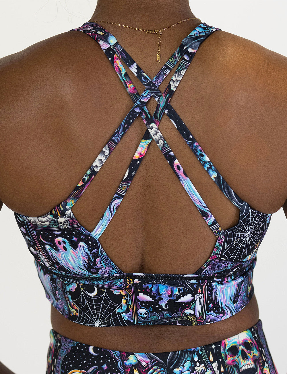 back of the rainbow skulls, jack o lantern, and ghosts bra against a white background