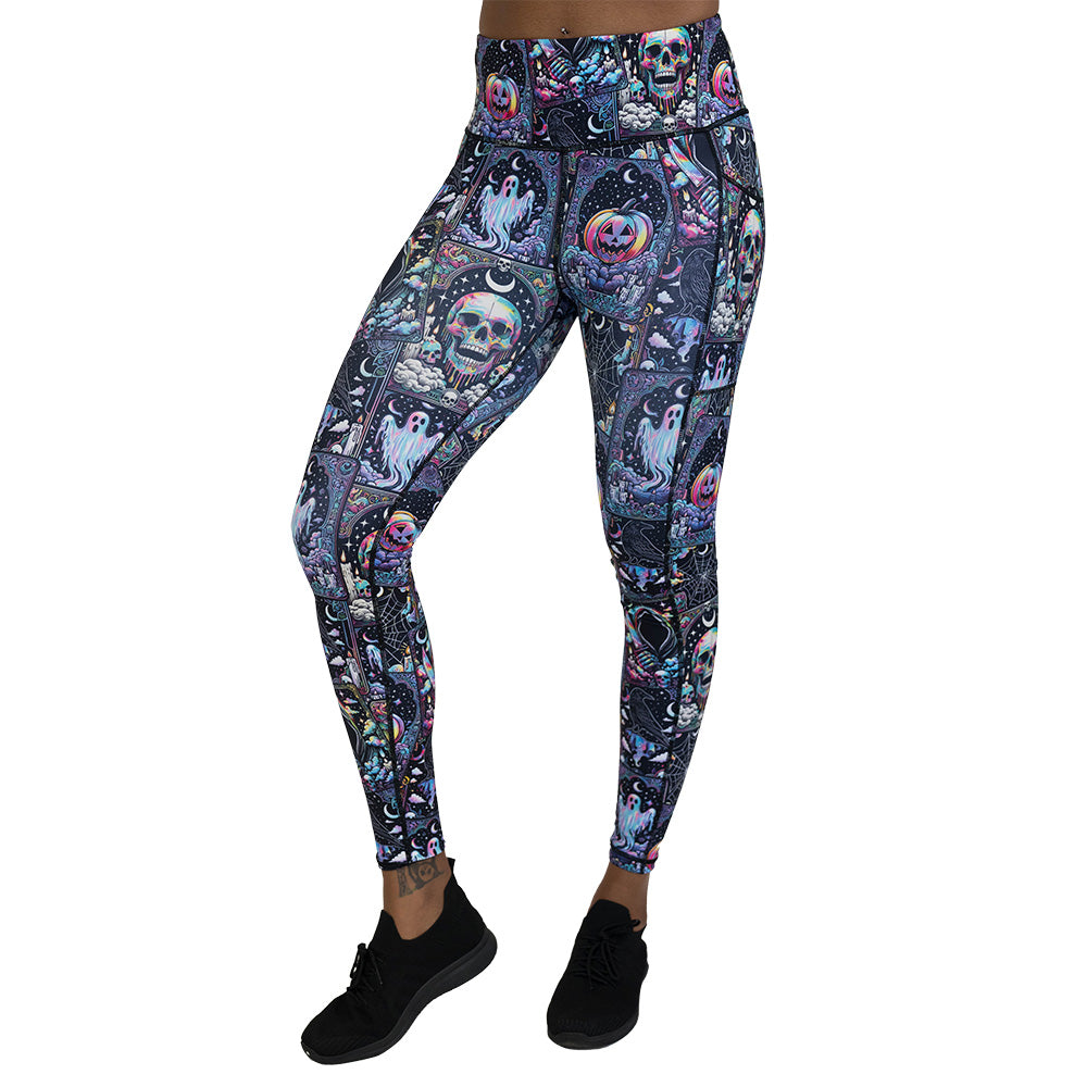 Colorful Halloween-themed leggings with skulls, ghosts, and pumpkins