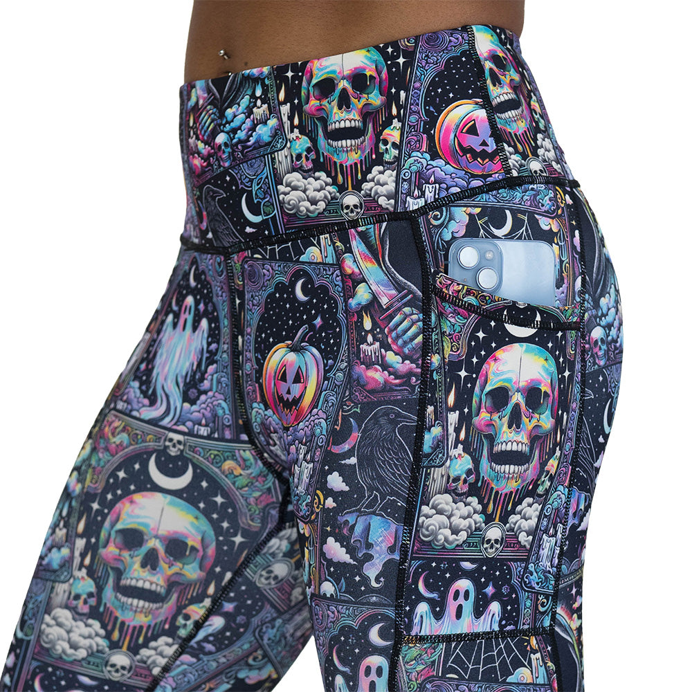 Colorful Halloween-themed leggings with skulls, ghosts, and pumpkins