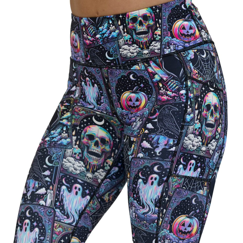 Colorful Halloween-themed leggings with skulls, ghosts, and pumpkins