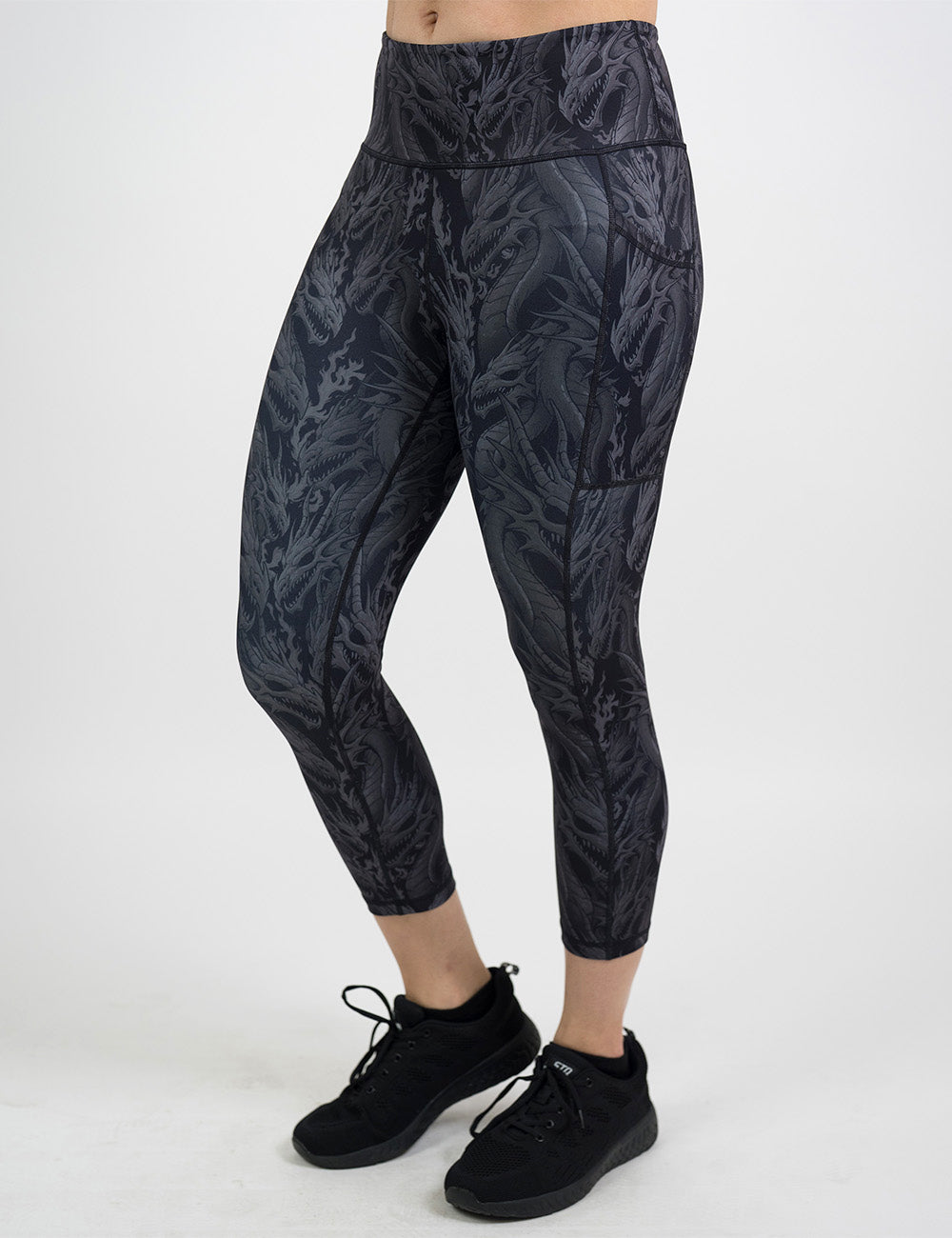 front of the capri black leggings with grey dragons against a white background