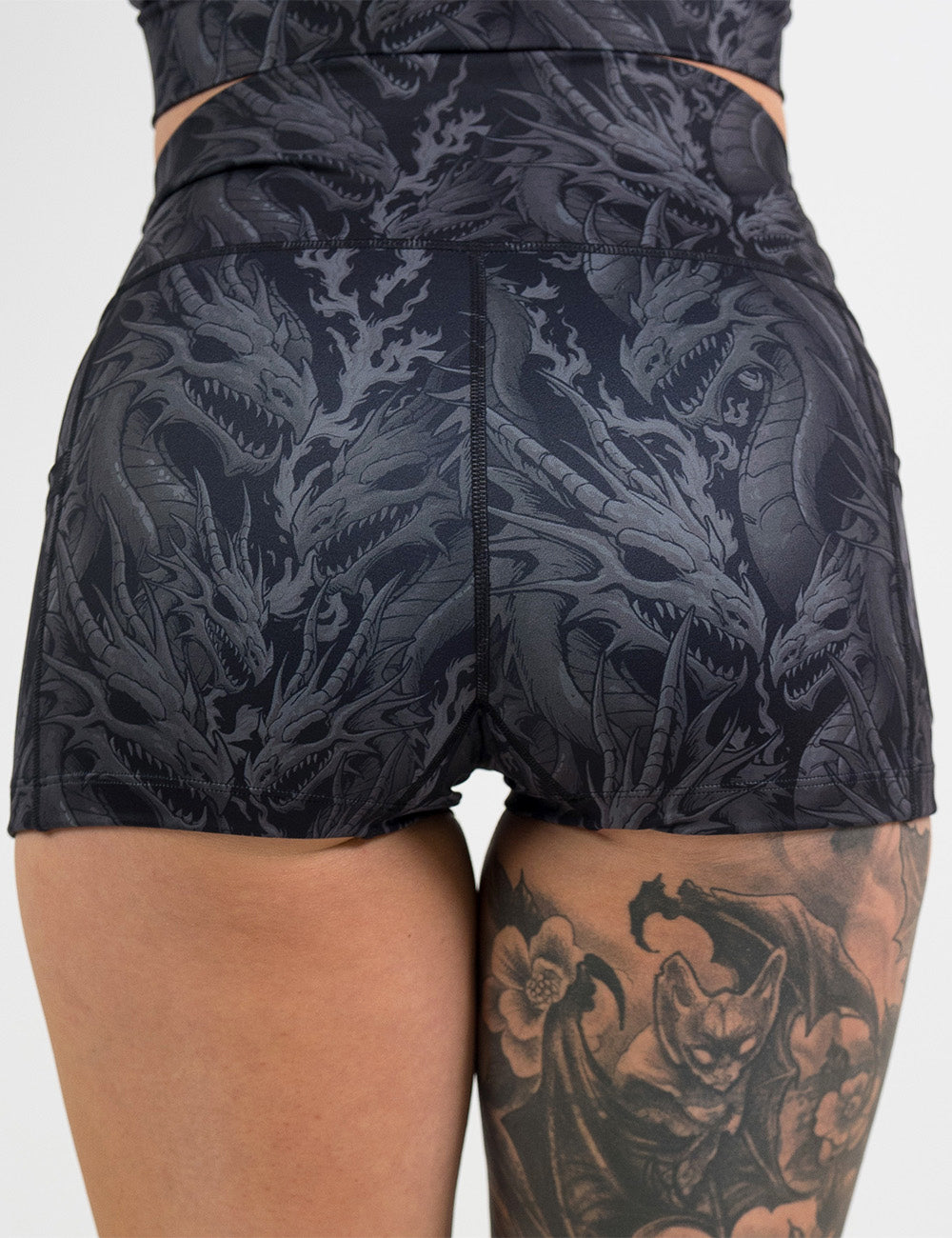 back of the 2.5 inch black shorts with a grey dragon pattern against a white background