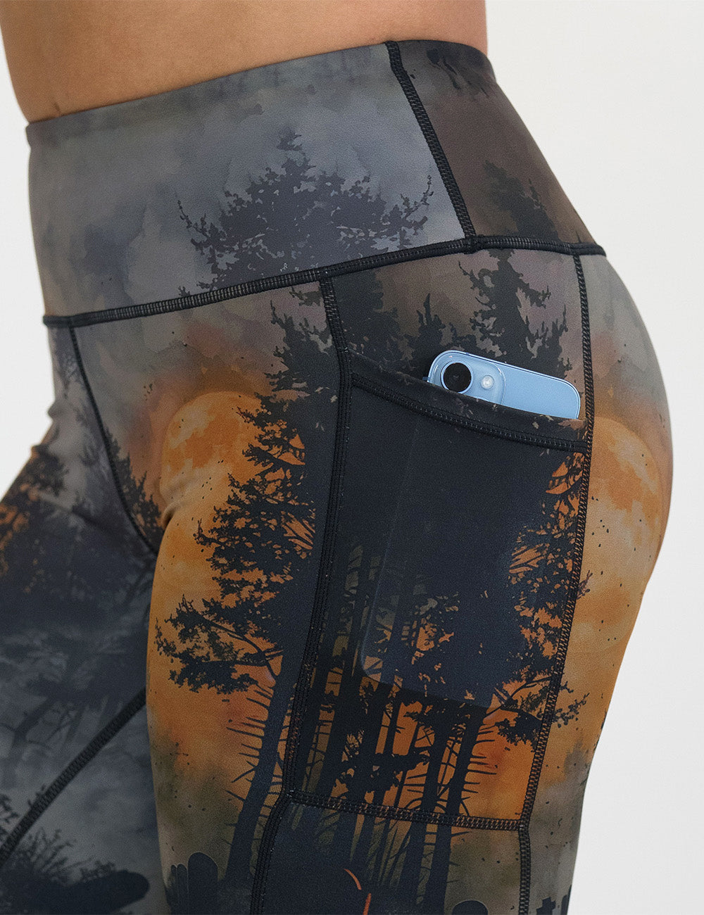 close up of the dark cemetery with a full moon leggings with a phone in its pocket