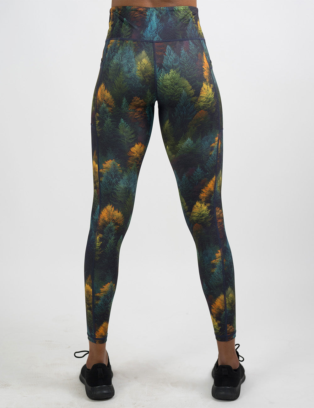 back of the orange, green, and bluish green trees full length leggings against a white background
