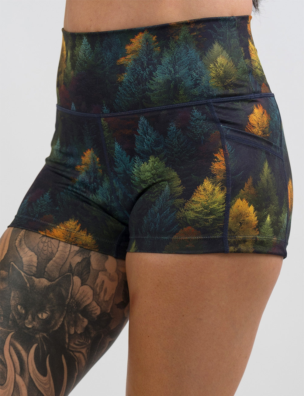 front of the 2.5 inch orange, green, and bluish green trees shorts against a white background