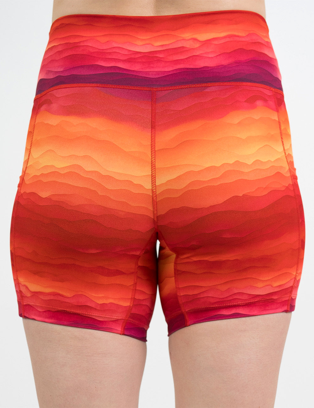 back of the 5 inch red, yellow, and orange sunset stripes pattern shorts against a white background
