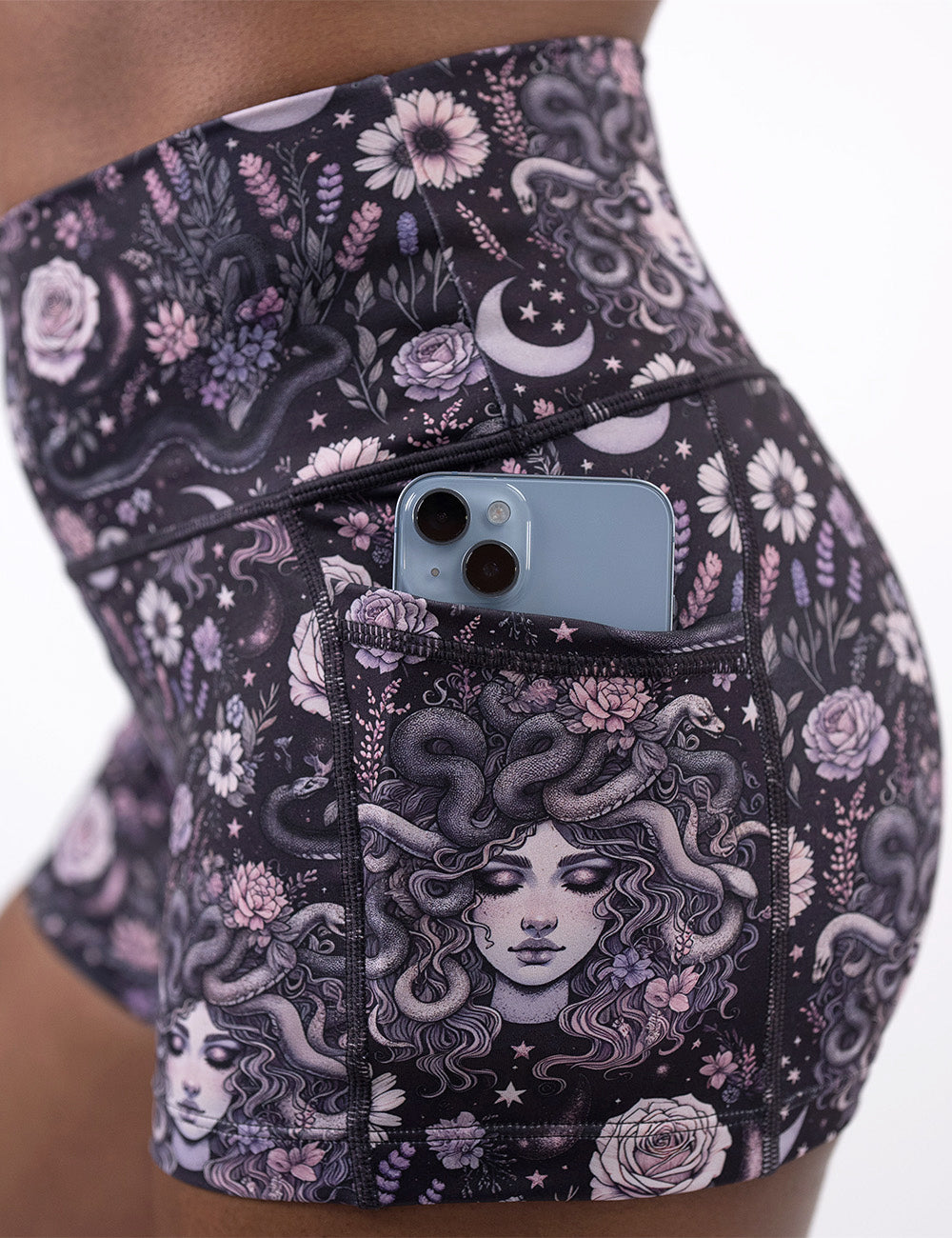 close up of the 2.5 inch purple medusa with flowers shorts with a phone in its pocket