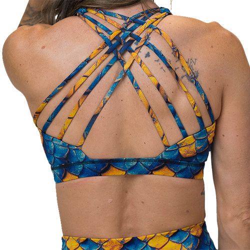 back of blue and yellow dragon scale print sports bra