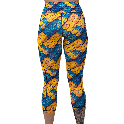 back of capri length blue and yellow dragon scale print leggings
