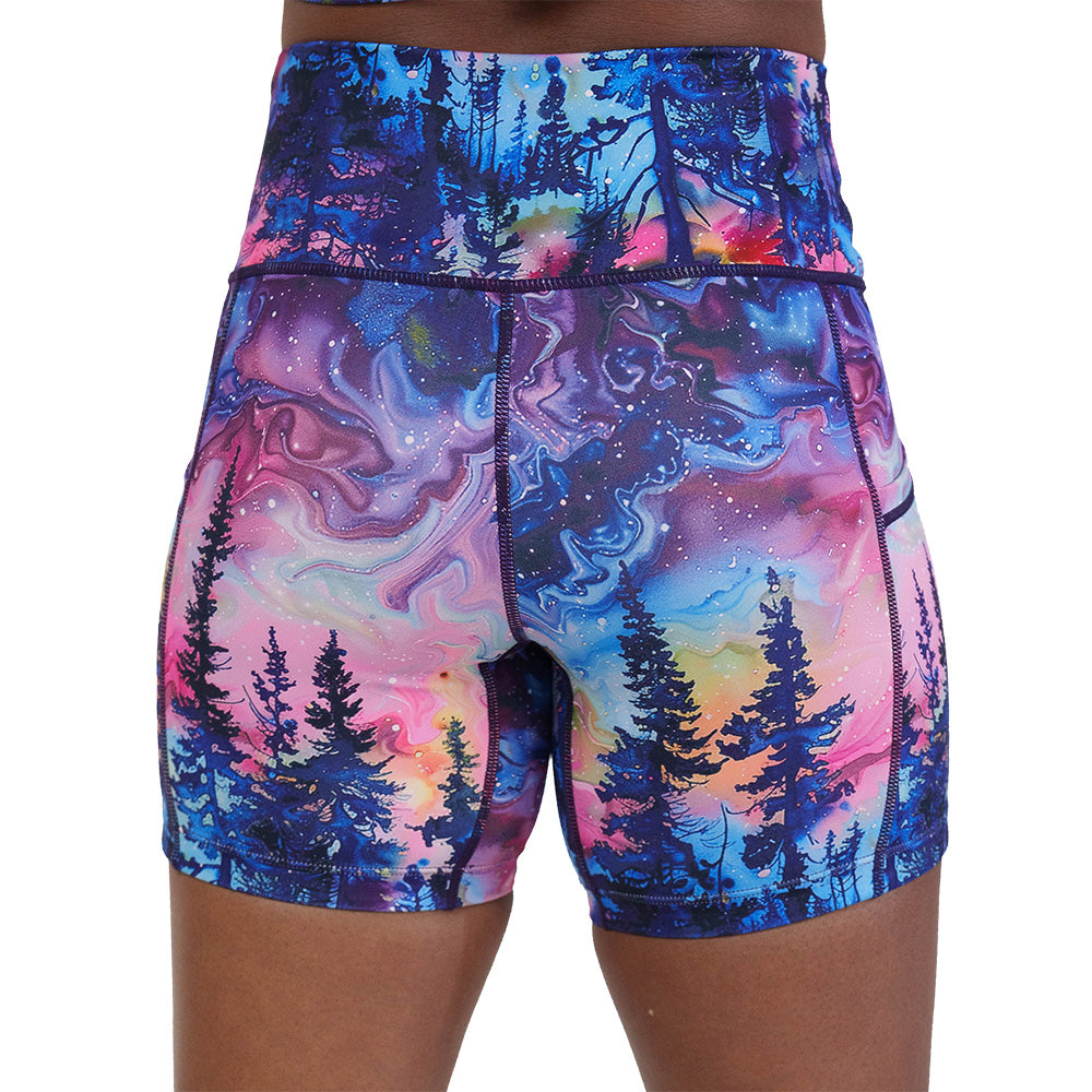 back of the watercolor rainbow patterned forest 5 inch shorts against a white background