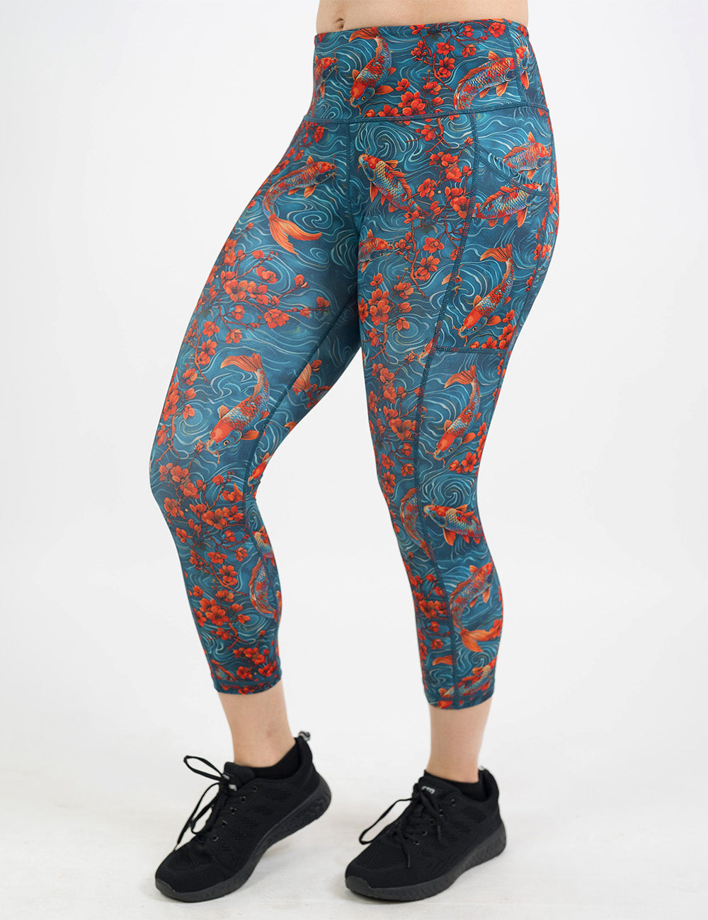 front of the koi fish swimming with orange flowers capri leggings
