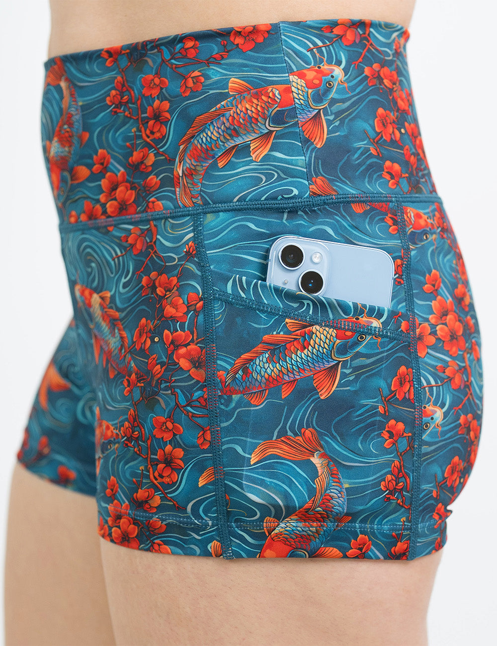 close up of the koi fish swimming with orange flowers 2.5 inch shorts holding a phone in its pocket