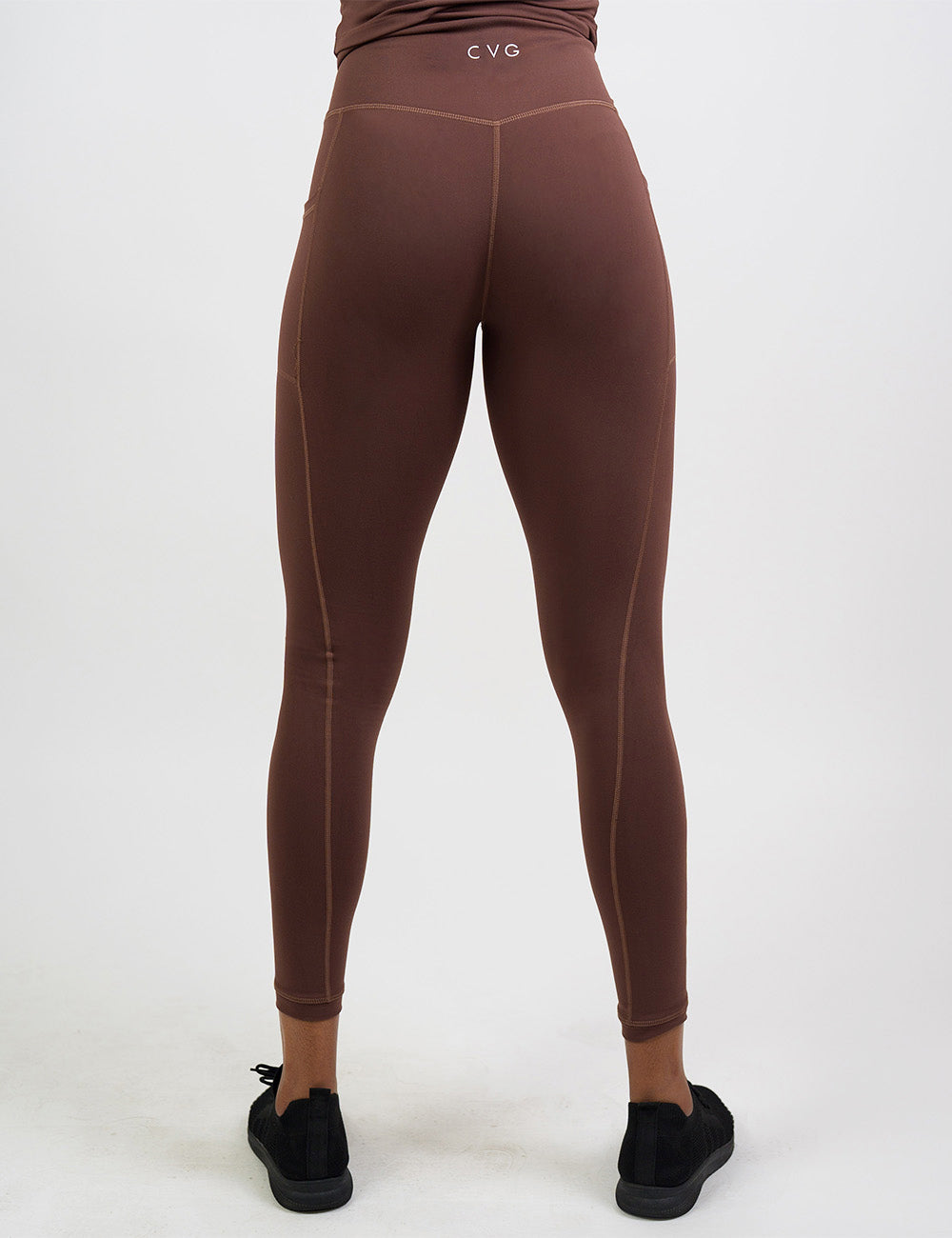 back of the full length solid light brown leggings against a white background