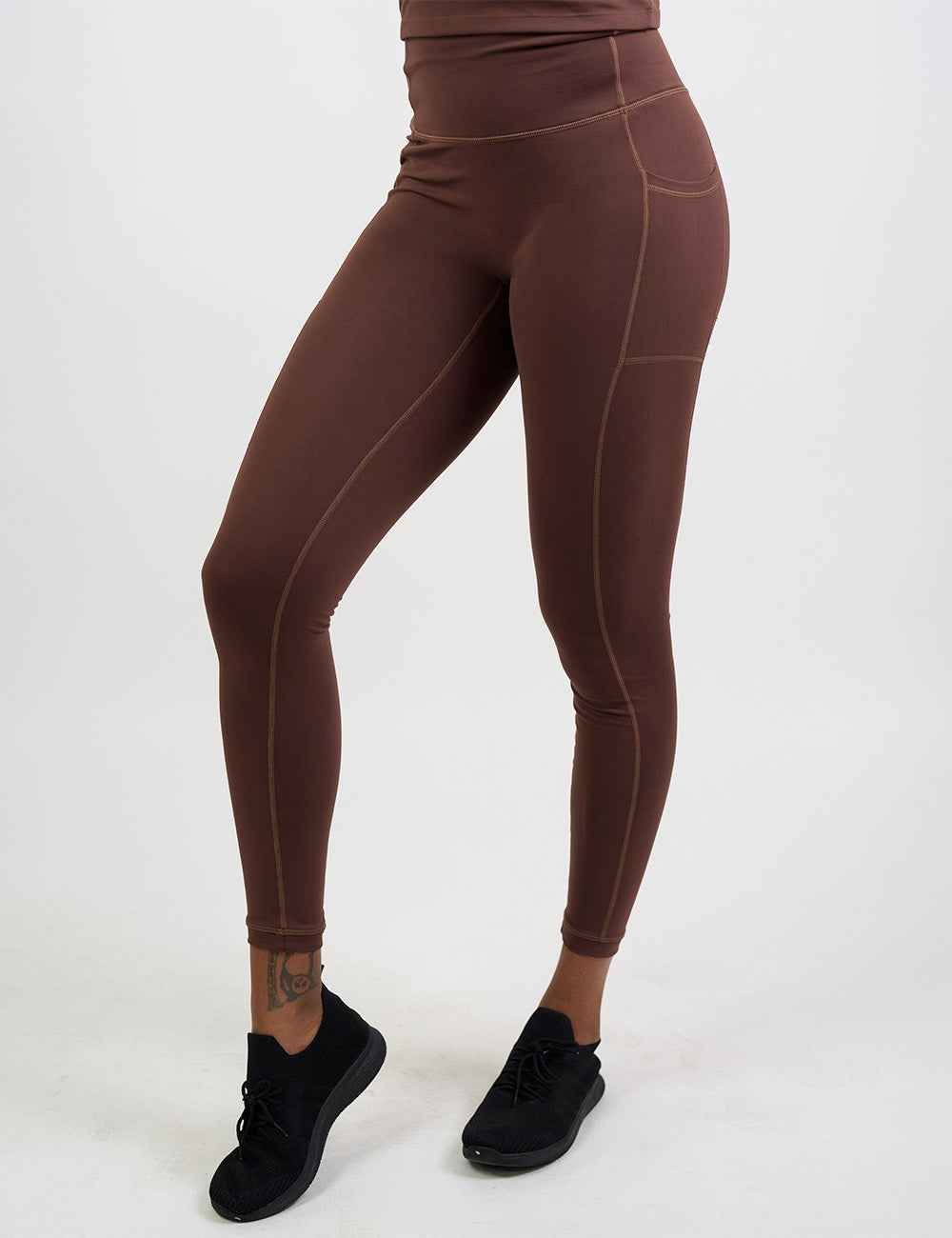 front of the solid light brown full length leggings against a white background