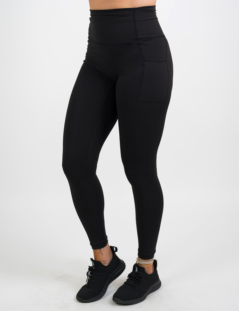 front of the all black essential style full length leggings against a white background