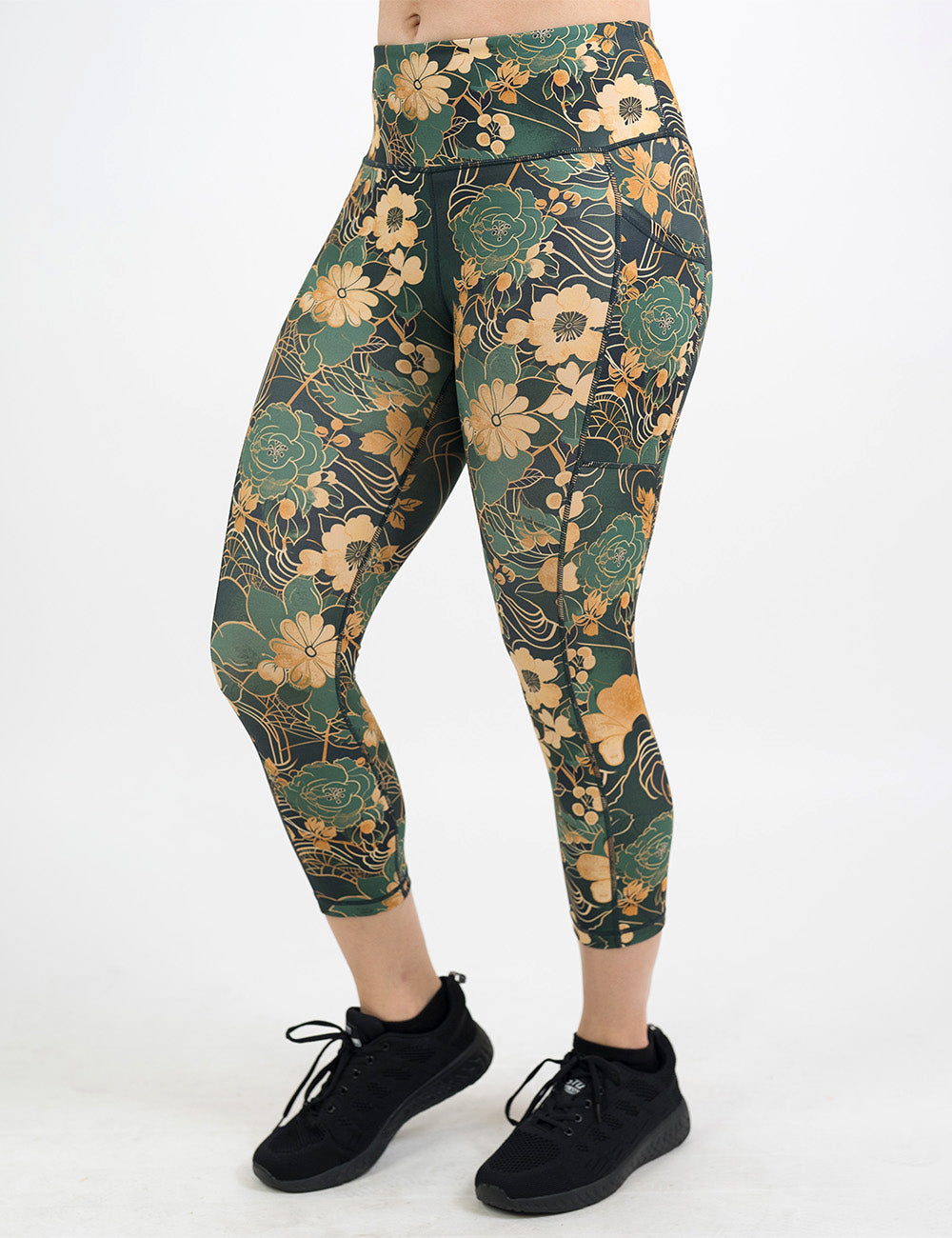 front of the gold and green flowers with gold accents pattern capri leggings