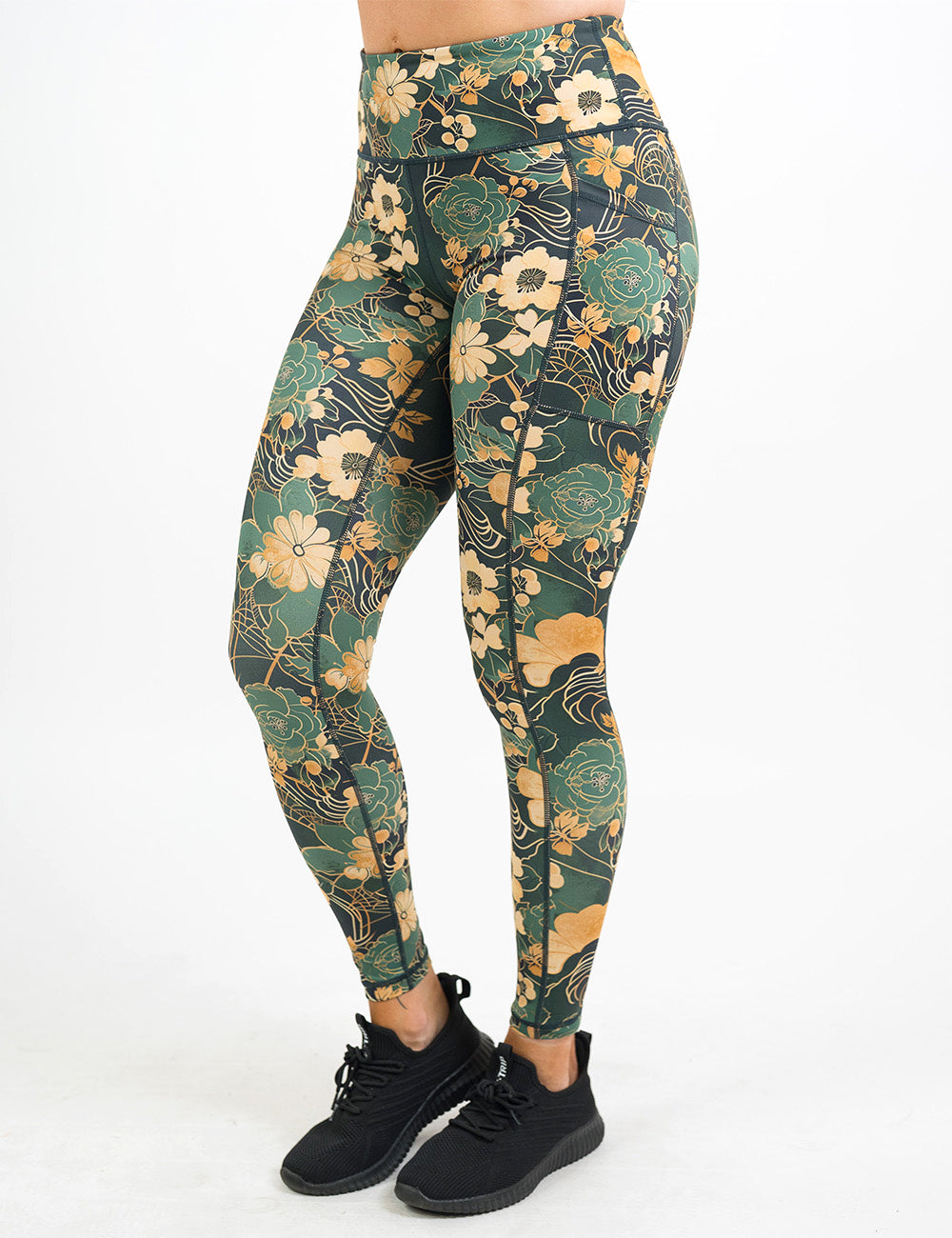 front of the full length gold and green flowers with gold accents pattern leggings