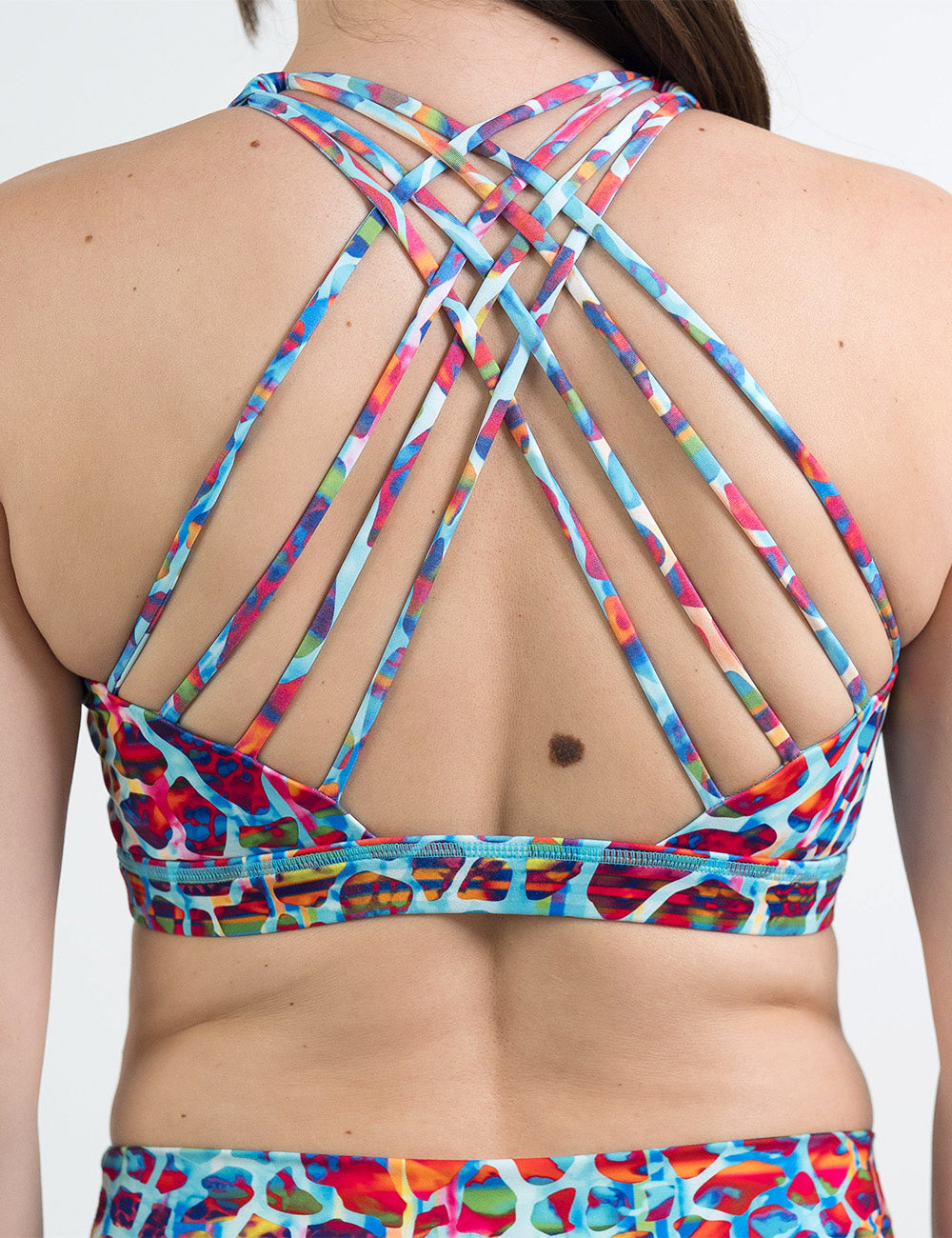 back of the yellow, orange, and blue mosaic style butterfly back bra against a white background