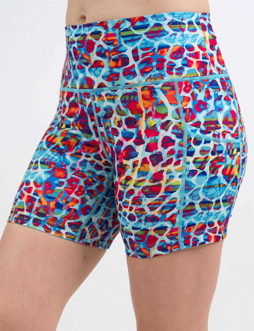 front of the 5 inch red, teal, and yellow mosaic style shorts against a white background